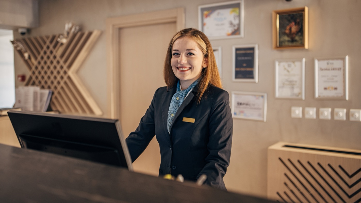 Front desk agent welcoming a guest